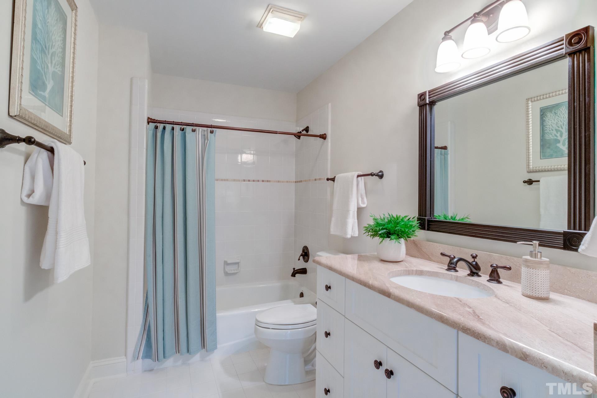 109 Ronsard Lane Cary, NC 27511 - Photo 22 of 26 a bathroom with a granite countertop sink toilet and shower