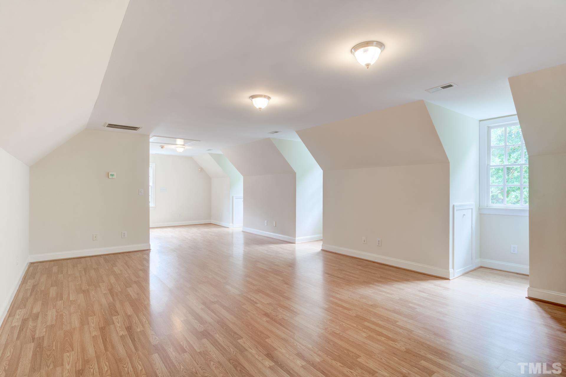 109 Ronsard Lane Cary, NC 27511 - Photo 24 of 26 a view of an empty room with wooden floor and a window