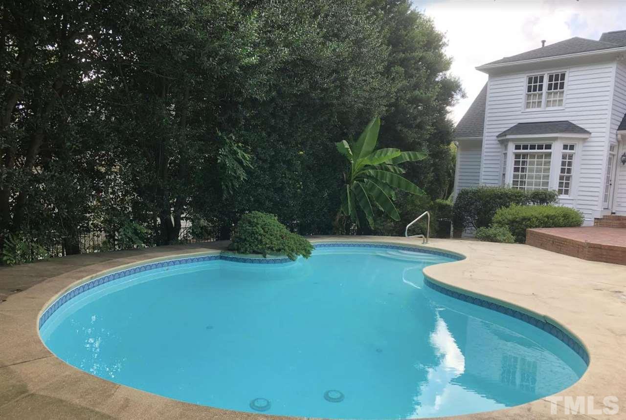 109 Ronsard Lane Cary, NC 27511 - Photo 4 of 26 a view of a swimming pool with a yard