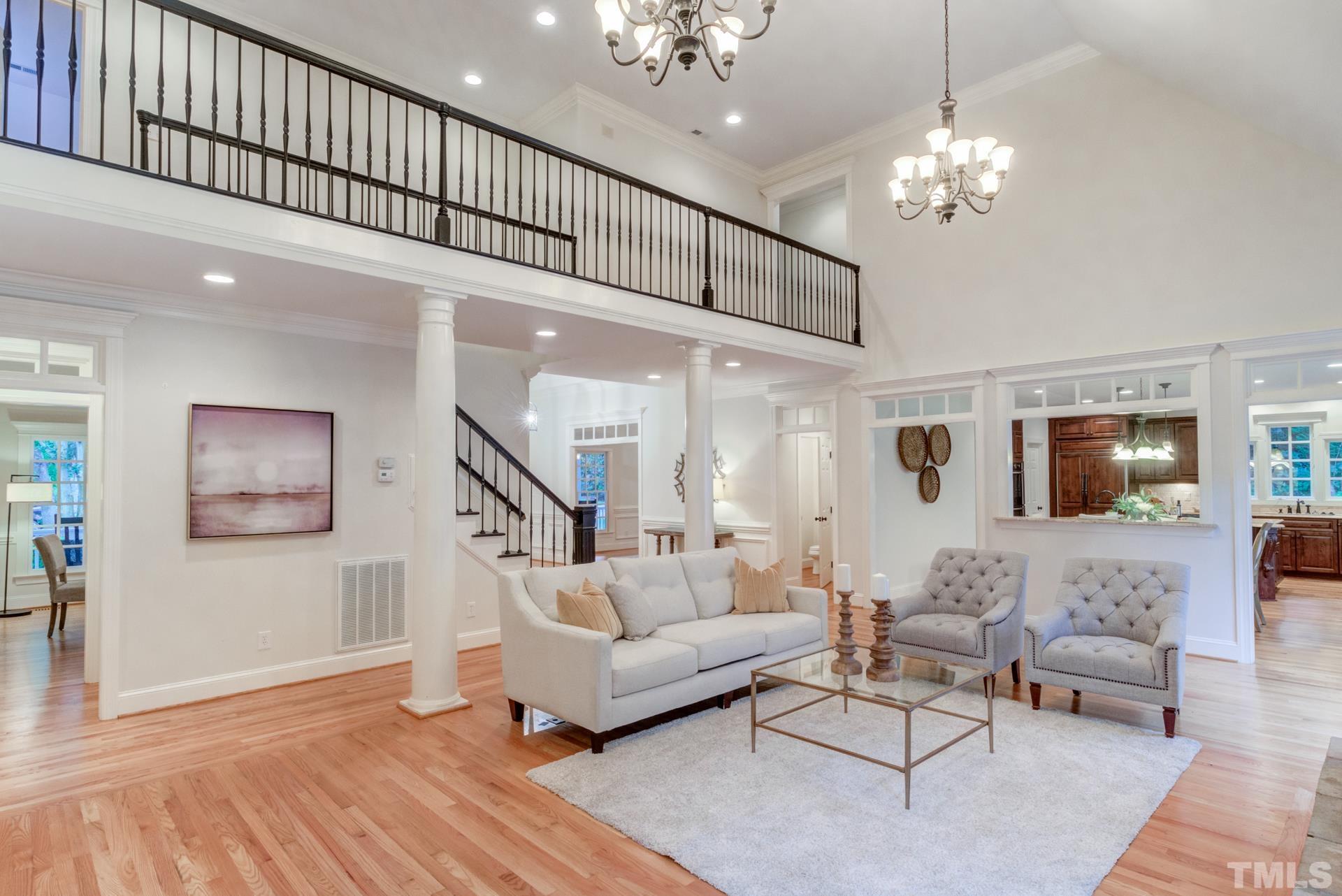 109 Ronsard Lane Cary, NC 27511 - Photo 6 of 26 a living room with furniture and a chandelier