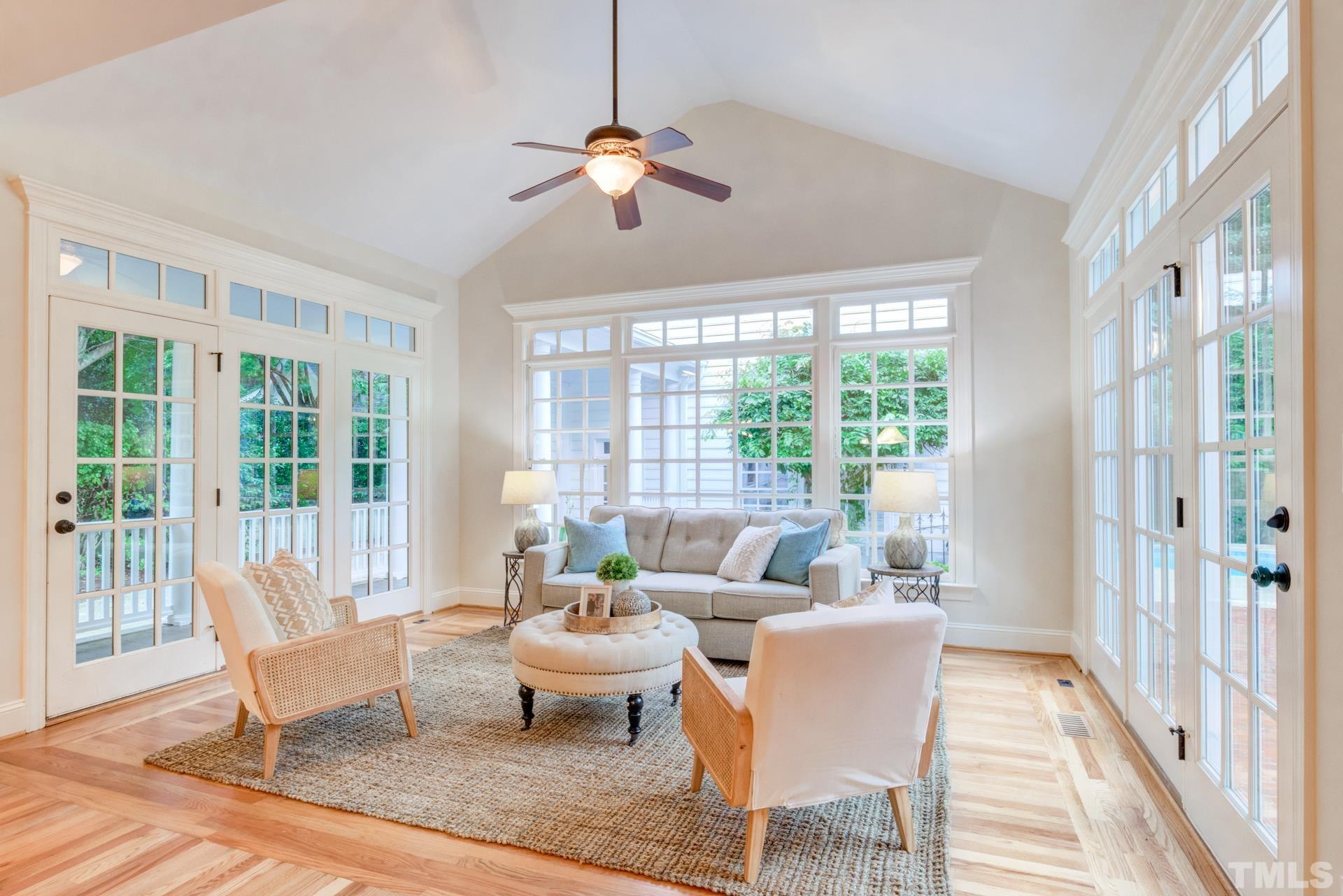 109 Ronsard Lane Cary, NC 27511 - Photo 9 of 26 a dining room with furniture a chandelier and wooden floor