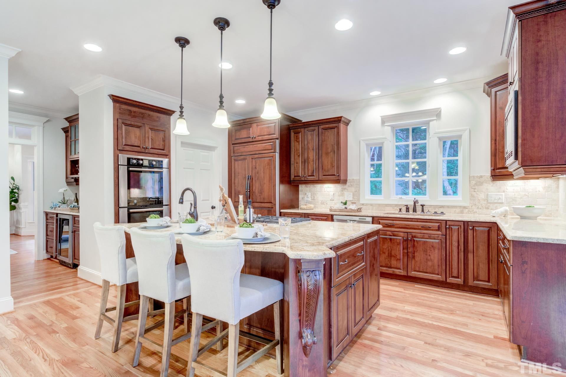 109 Ronsard Lane Cary, NC 27511 - Photo 10 of 26 a kitchen with stainless steel appliances granite countertop a stove a sink island and a refrigerator