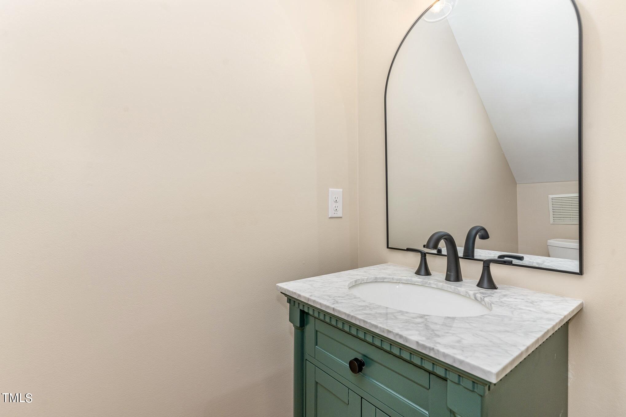 2204 Dunlin Lane Raleigh, NC 27614 - Photo 11 of 32 a bathroom with a granite countertop sink and a mirror