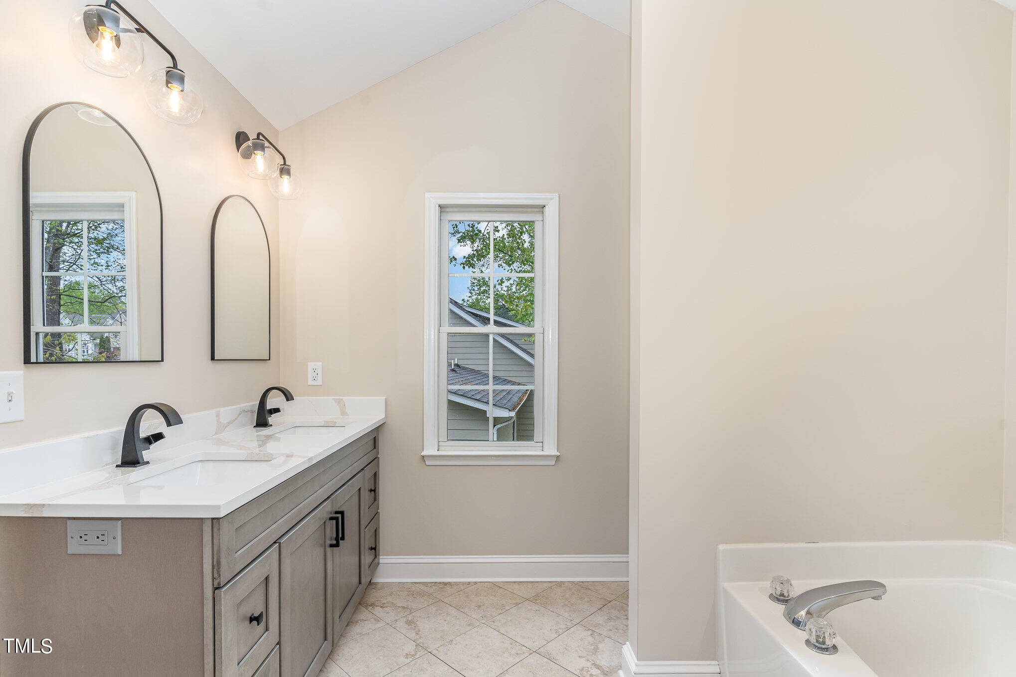 2204 Dunlin Lane Raleigh, NC 27614 - Photo 13 of 32 a bathroom with a double vanity sink and a window
