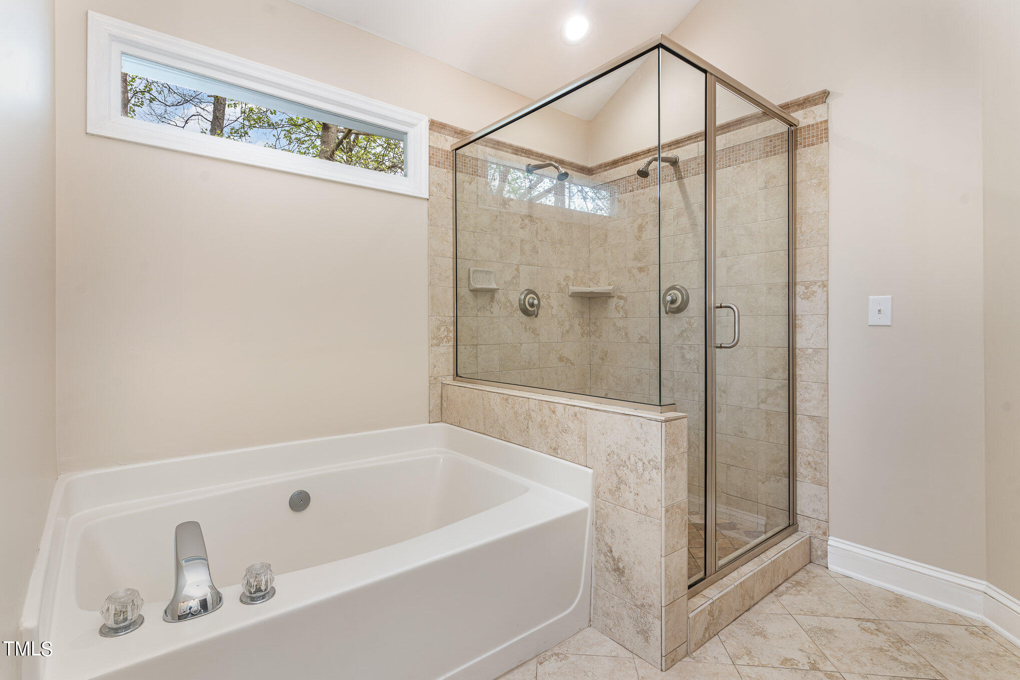 2204 Dunlin Lane Raleigh, NC 27614 - Photo 14 of 32 a bathroom with a tub a sink and glass door shower
