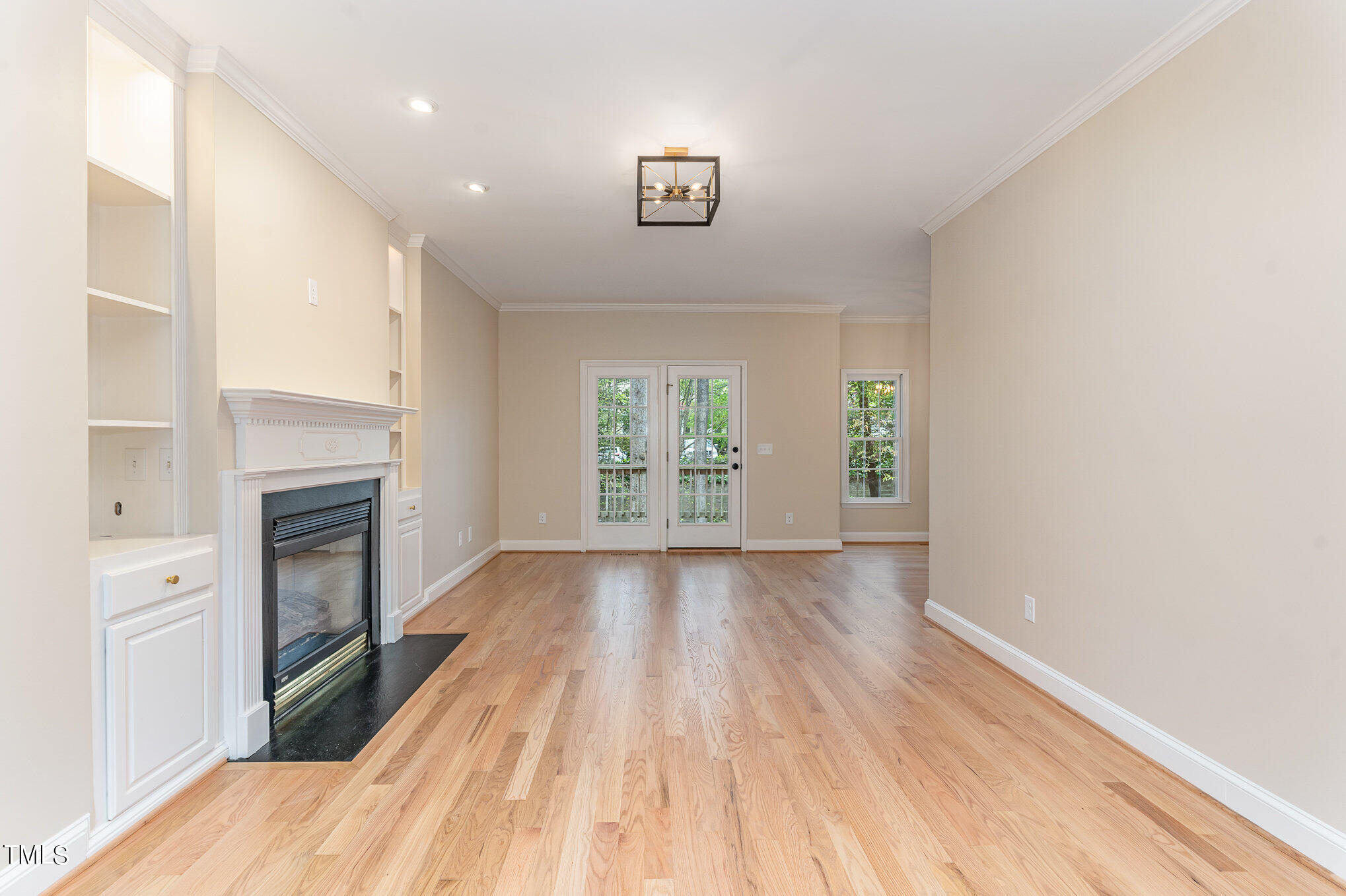 2204 Dunlin Lane Raleigh, NC 27614 - Photo 5 of 32 a view of empty room with wooden floor and fireplace