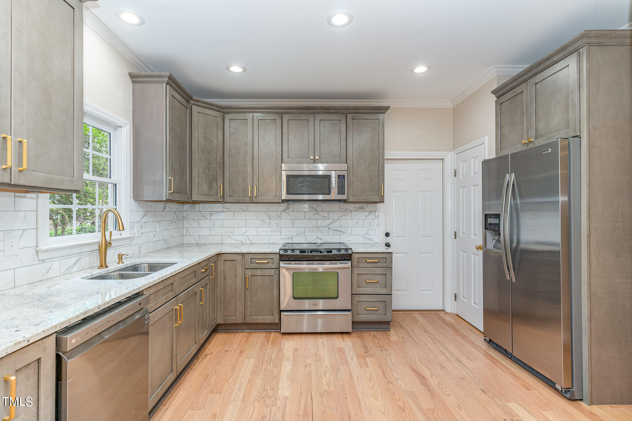 2204 Dunlin Lane Raleigh, NC 27614 - Photo 7 of 32 a kitchen with stainless steel appliances granite countertop a stove a sink and a refrigerator