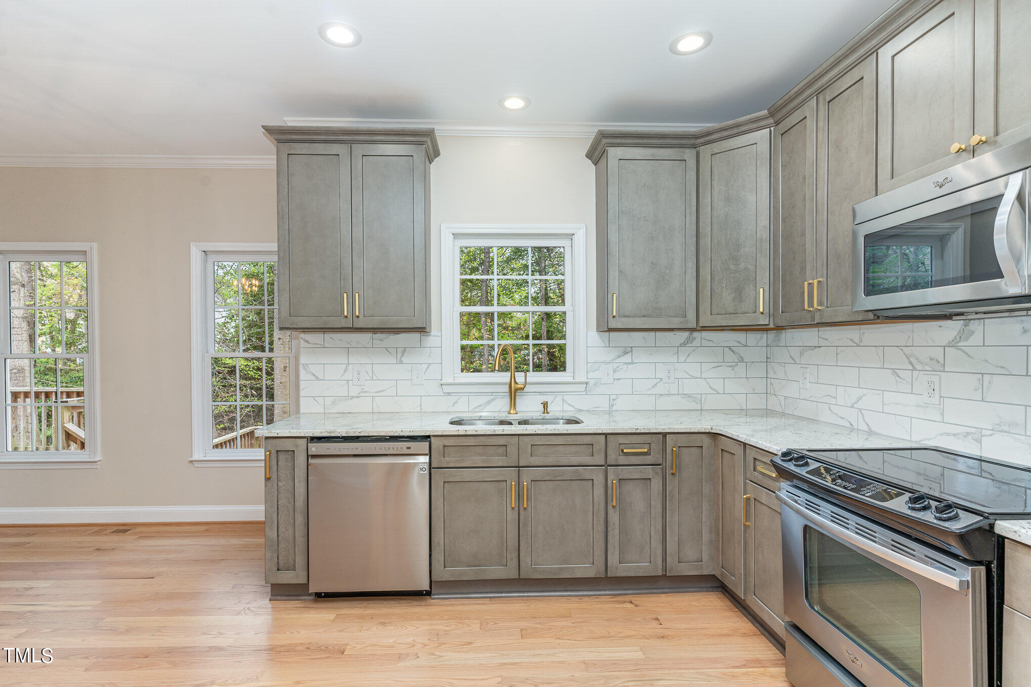 2204 Dunlin Lane Raleigh, NC 27614 - Photo 8 of 32 a kitchen with a sink stove and cabinets