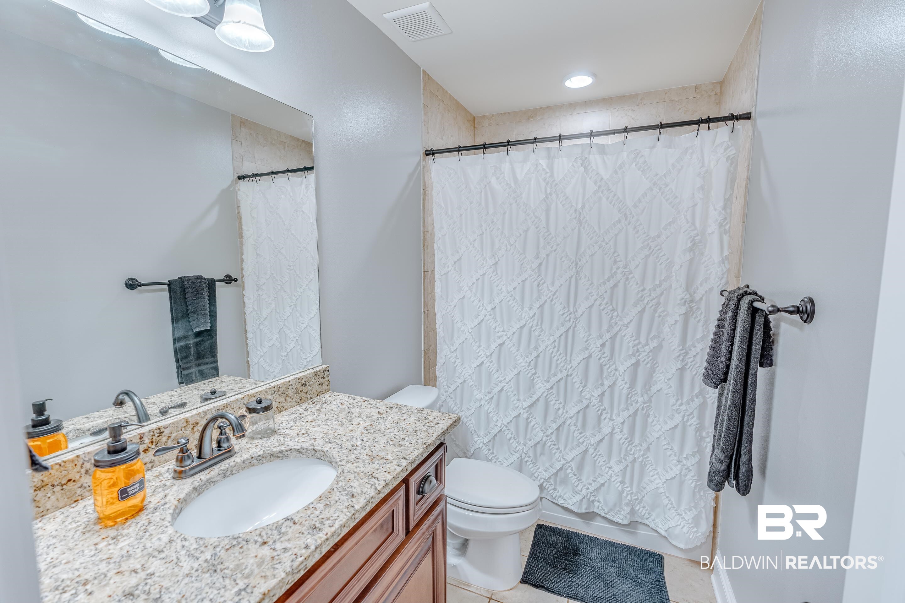 13235 Tom Gaston Road Mobile, AL 36695 - Photo 21 of 43 Bathroom featuring tile patterned flooring, vanity, walk in shower, and toilet