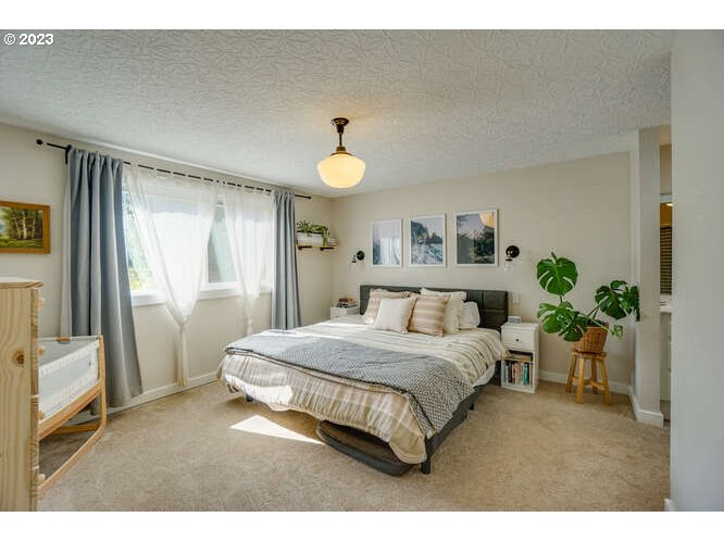111 Northeast 19th Avenue Camas, WA 98607 - Photo 27 of 48 a bedroom with a bed and a potted plant