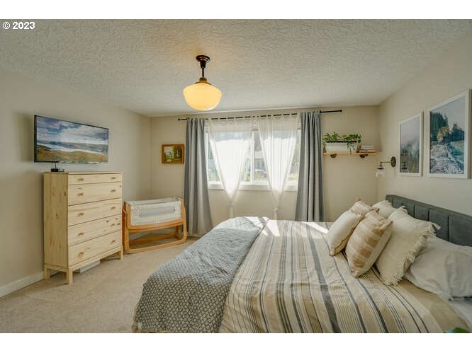 111 Northeast 19th Avenue Camas, WA 98607 - Photo 28 of 48 a bedroom with a bed and wooden floor