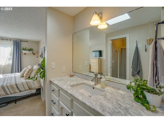 111 Northeast 19th Avenue Camas, WA 98607 - Photo 30 of 48 a en suite bathroom with a granite countertop sink and a mirror