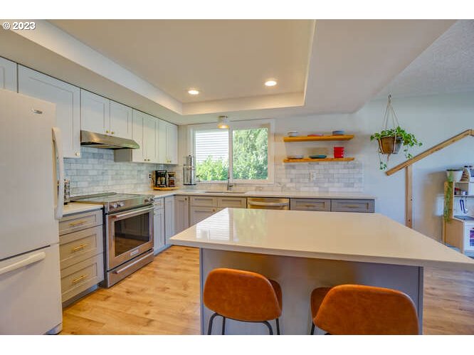 111 Northeast 19th Avenue Camas, WA 98607 - Photo 7 of 48 a kitchen with stainless steel appliances granite countertop a sink and a stove