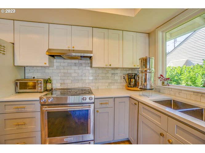 111 Northeast 19th Avenue Camas, WA 98607 - Photo 9 of 48 a kitchen with stainless steel appliances granite countertop a sink a stove and cabinets