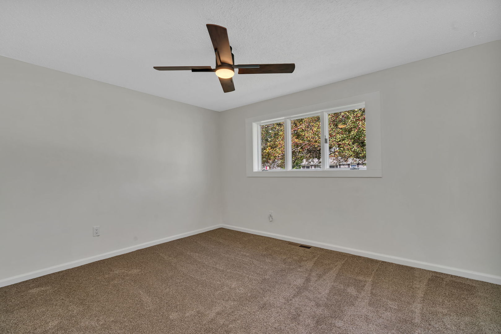 53 Duncan Drive Bourbonnais, IL 60914 - Photo 15 of 49 an empty room with a window and a ceiling fan