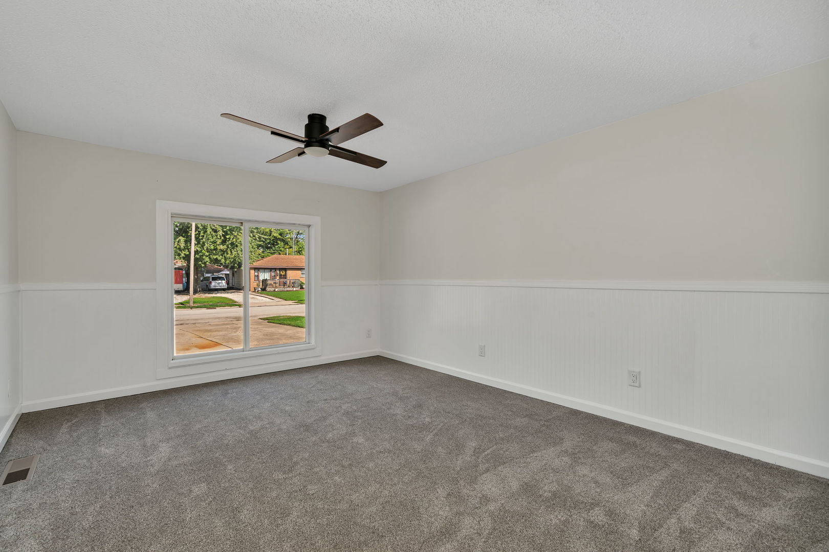 53 Duncan Drive Bourbonnais, IL 60914 - Photo 19 of 49 an empty room with chandelier fan and windows