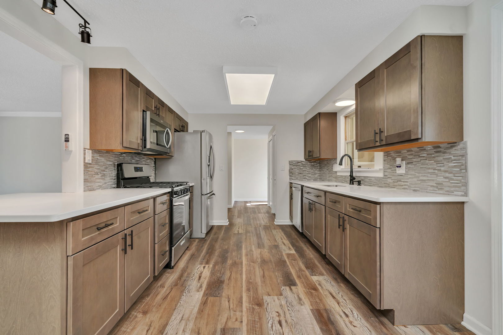 53 Duncan Drive Bourbonnais, IL 60914 - Photo 8 of 49 a kitchen with stainless steel appliances granite countertop a sink stove cabinets and wooden floor