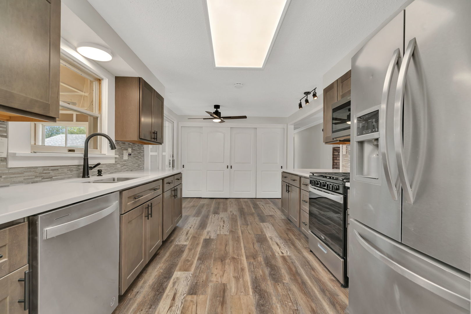 53 Duncan Drive Bourbonnais, IL 60914 - Photo 9 of 49 a kitchen with granite countertop a sink stove and refrigerator