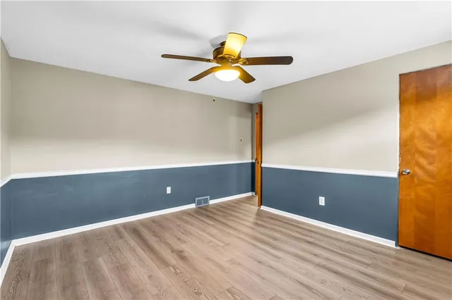 a view of a room with wooden floor