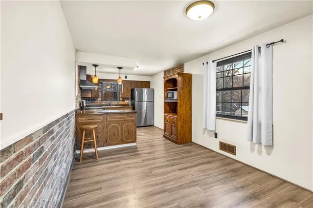 a kitchen with stainless steel appliances a refrigerator and a stove top oven