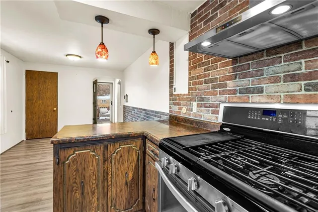 a stove top oven sitting inside of a kitchen