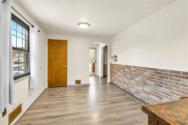 a view of an entryway with wooden floor
