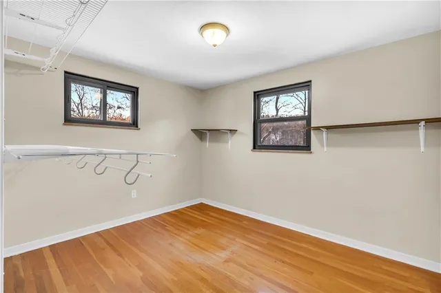 a view of a room with wooden floor and a window