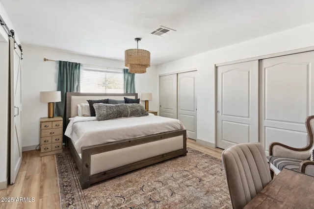 a bedroom with a bed and a chandelier