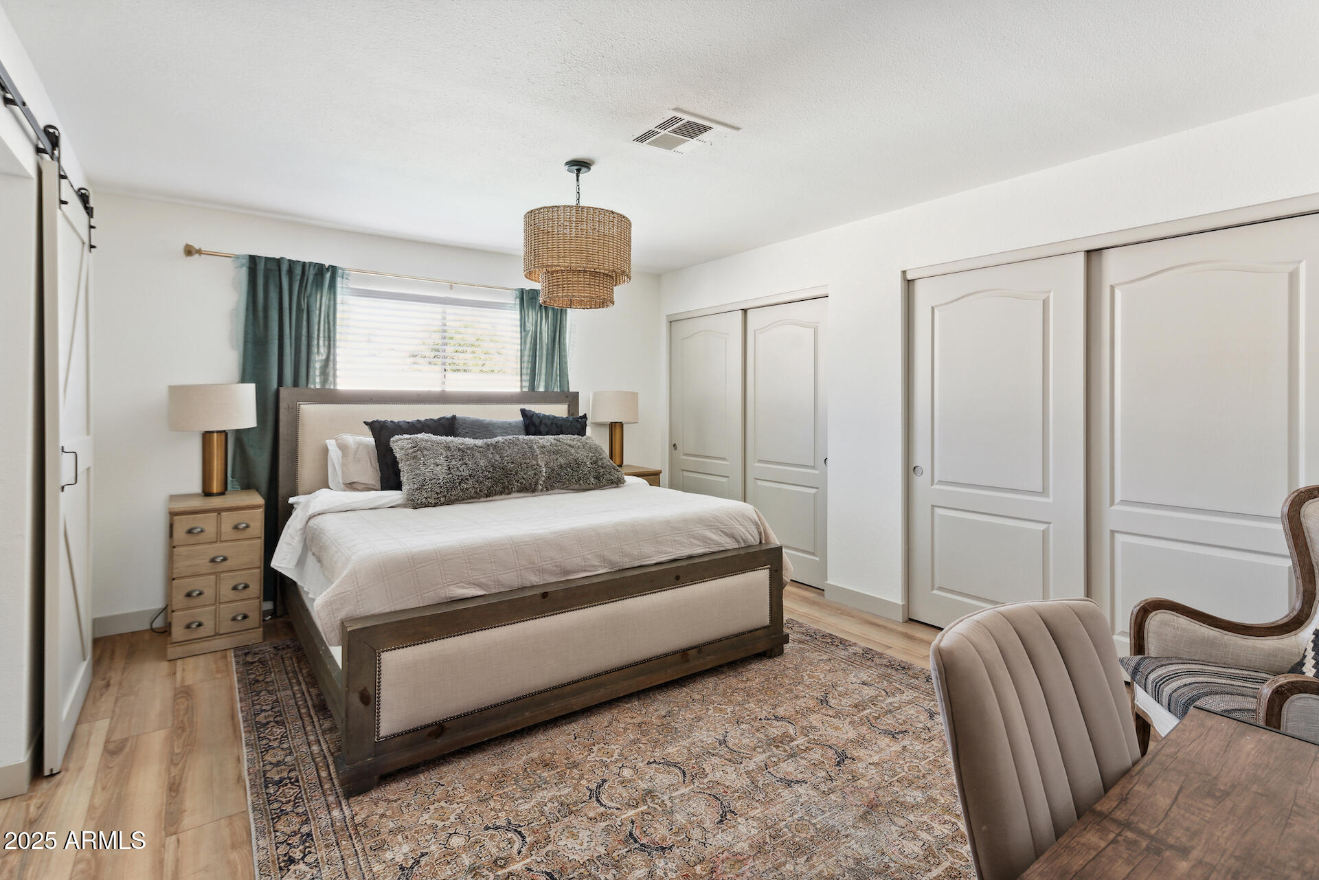 15641 North 63rd Street Scottsdale, AZ 85254 - Photo 12 of 32 a bedroom with a bed and a chandelier