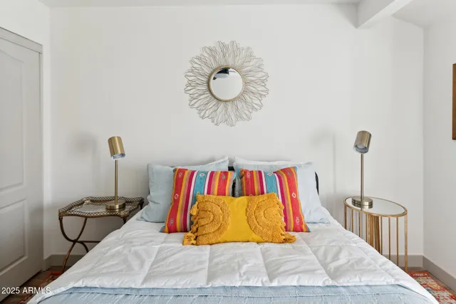 a room with a rug and a wall painting