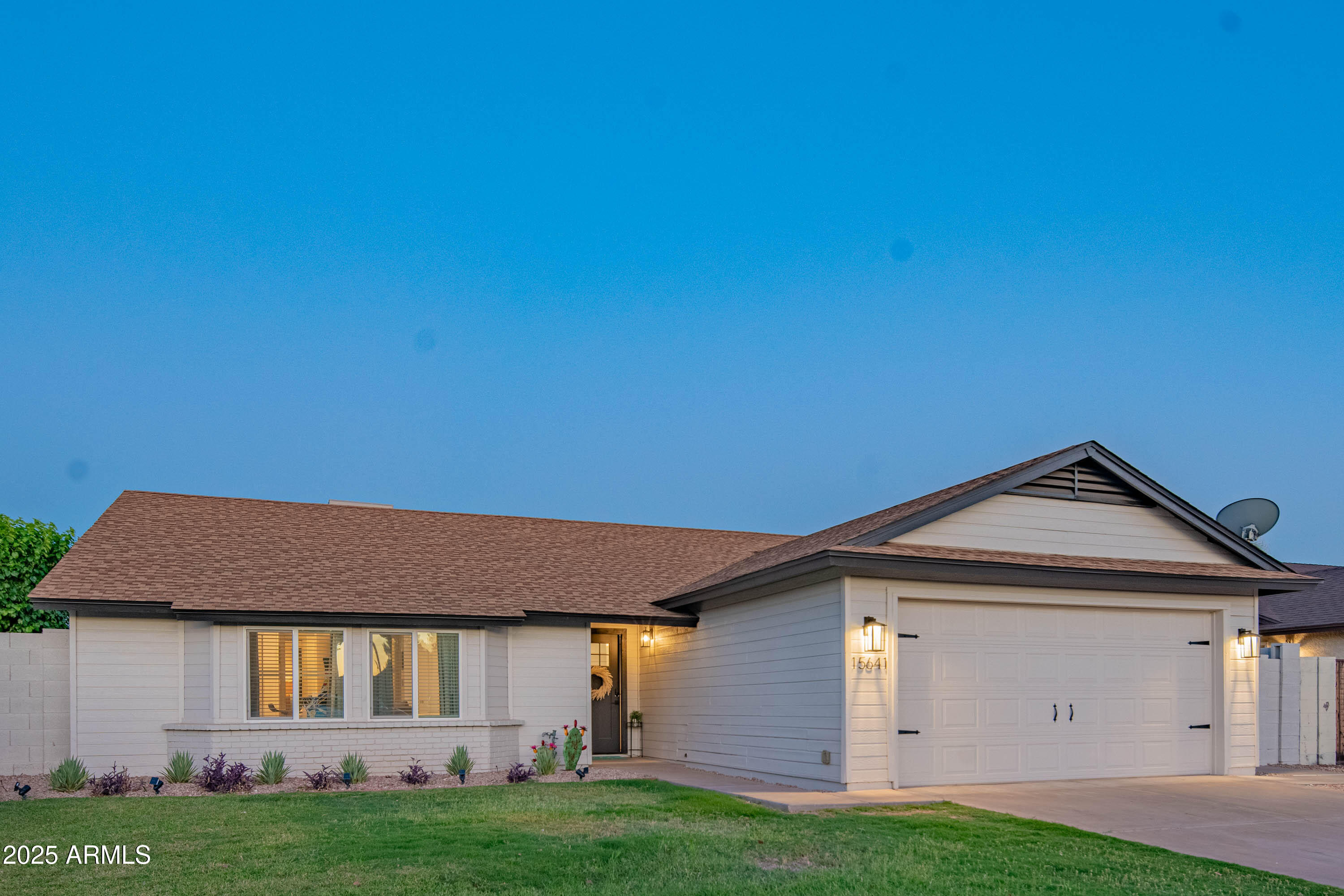 15641 North 63rd Street Scottsdale, AZ 85254 - Photo 2 of 32 a front view of a house with a yard