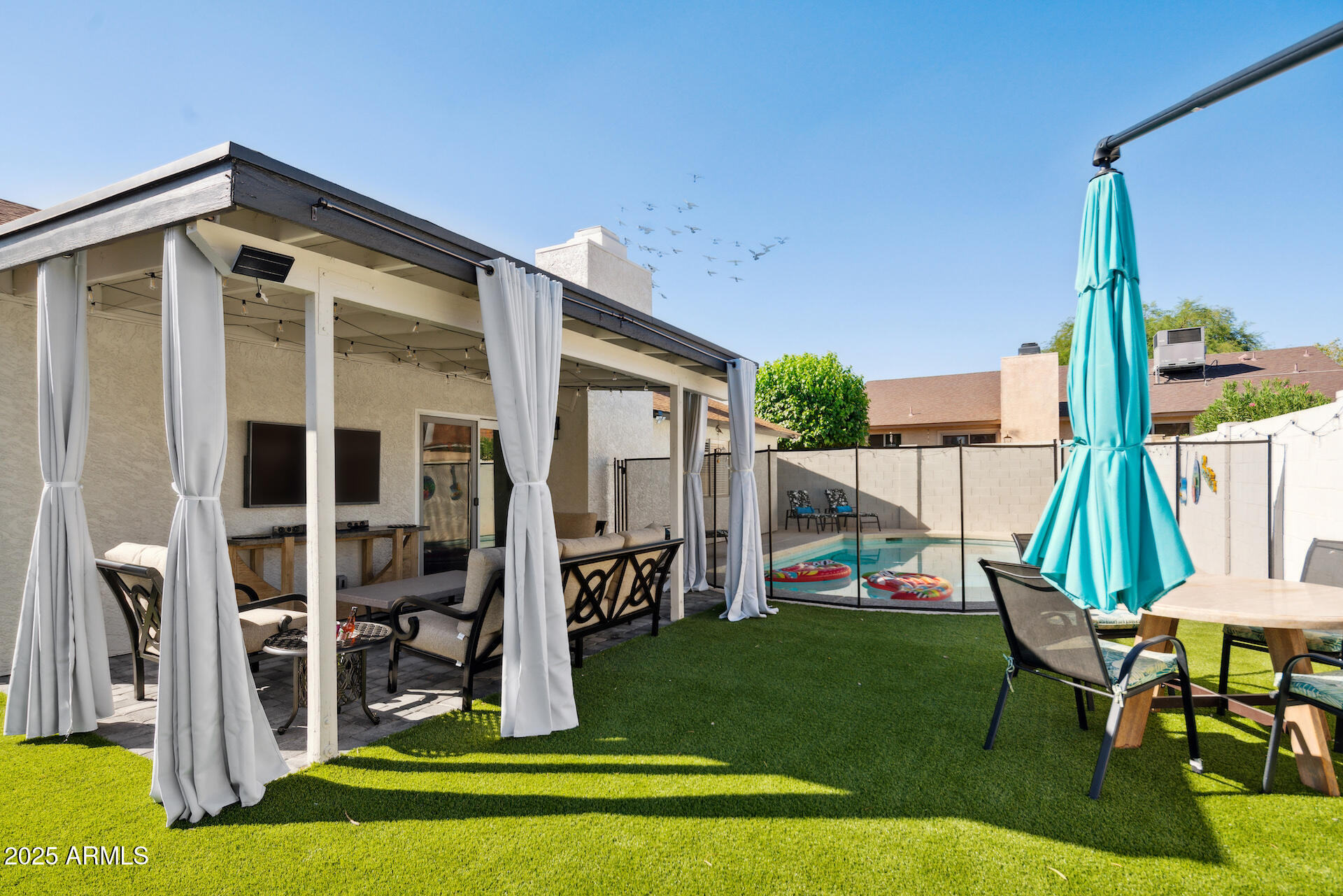 15641 North 63rd Street Scottsdale, AZ 85254 - Photo 29 of 32 a front view of a house with a yard table and chairs
