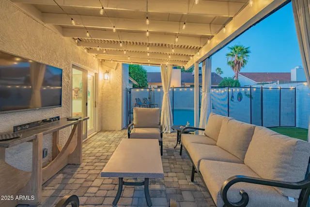 a backyard of a house with table and chairs