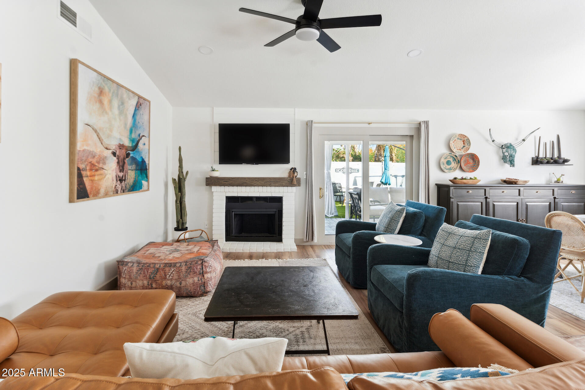15641 North 63rd Street Scottsdale, AZ 85254 - Photo 5 of 32 a living room with furniture a fireplace and a flat screen tv