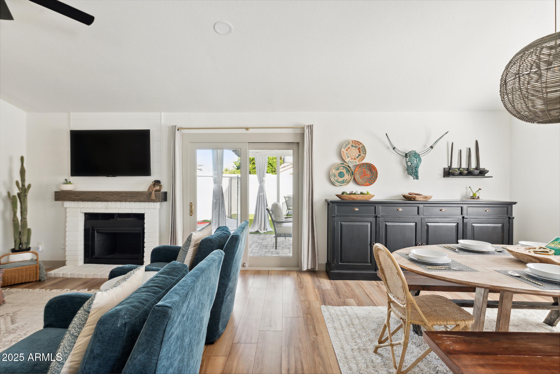 15641 North 63rd Street Scottsdale, AZ 85254 - Photo 9 of 32 a living room with furniture a fireplace and a flat screen tv