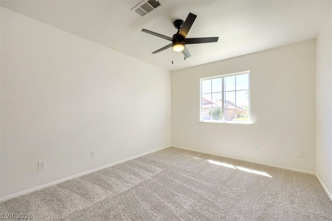 340 Kenya Road Las Vegas, NV 89119 - Photo 11 of 17 Plush carpet flooring and a multi-pane window complete this comfortable room.