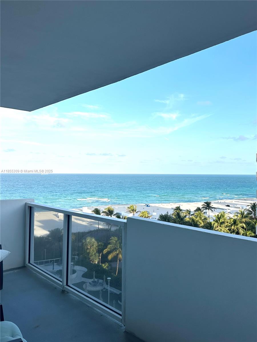100 Lincoln Road, Unit 936 Miami Beach, FL 33139 - Photo 2 of 8 a view of roof deck with wooden floor and dining space