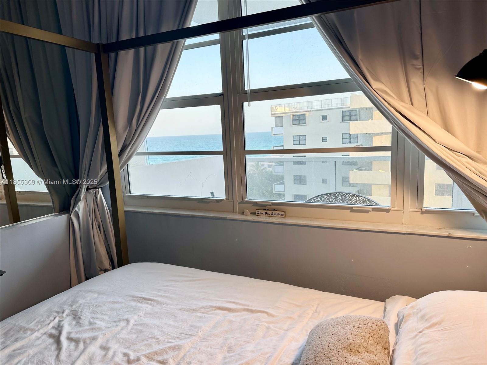 100 Lincoln Road, Unit 936 Miami Beach, FL 33139 - Photo 3 of 8 a bedroom with a bed and a large window