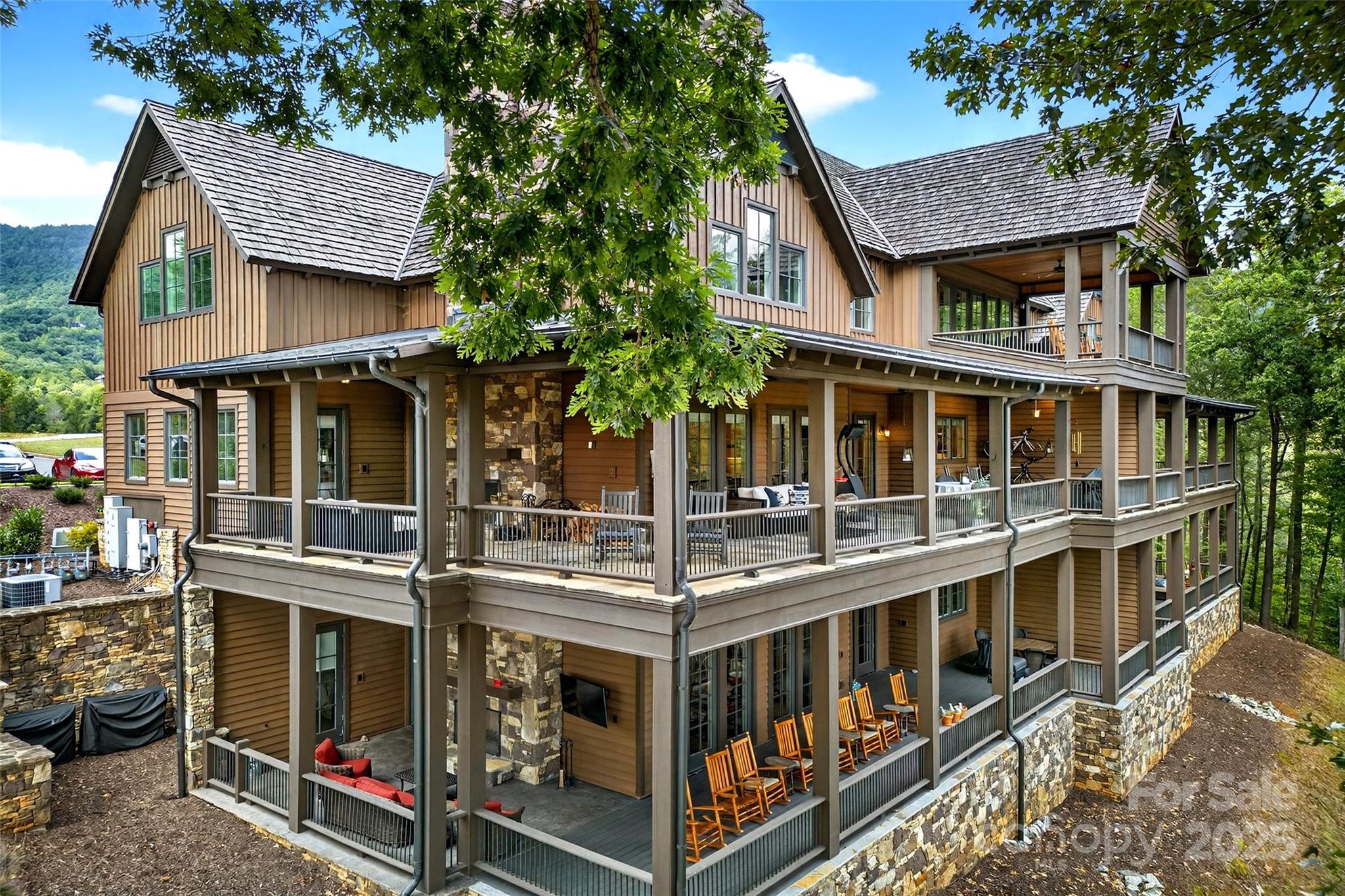a view of a large building with a small yard and large tree