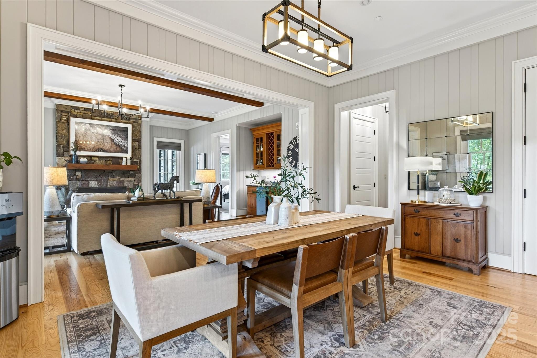275 Clubhouse, Unit C202 Mill Spring, NC 28756 - Photo 11 of 48 a dining room with furniture a kitchen view and a chandelier