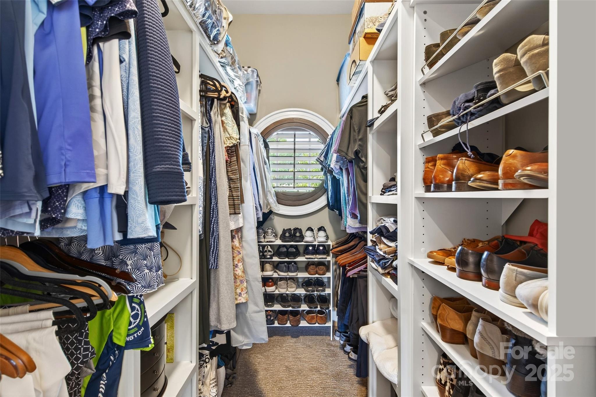 275 Clubhouse, Unit C202 Mill Spring, NC 28756 - Photo 21 of 48 a view of walk in closet with clothes and shoes
