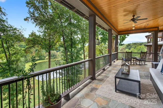 a view of balcony with chairs and wooden fence