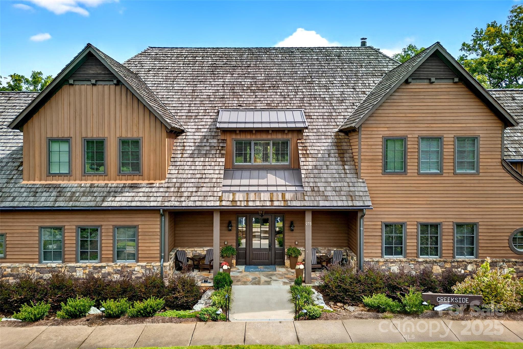 275 Clubhouse, Unit C202 Mill Spring, NC 28756 - Photo 33 of 48 a front view of a house with garage and plants