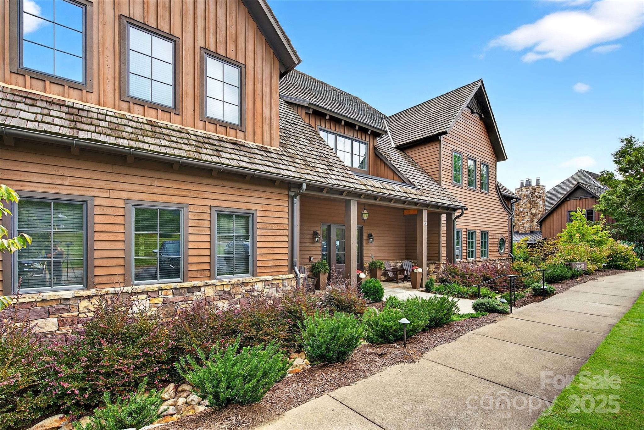 275 Clubhouse, Unit C202 Mill Spring, NC 28756 - Photo 34 of 48 a front view of a house with garden