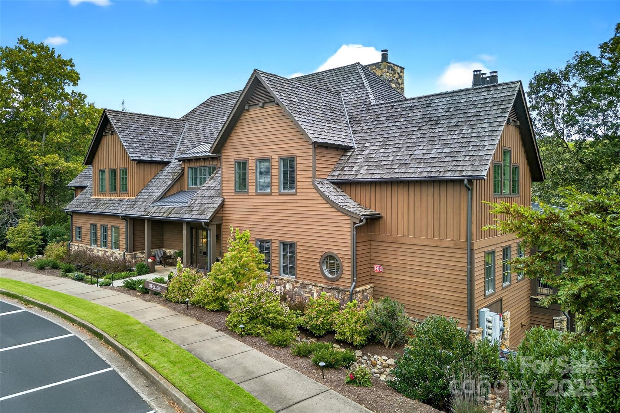 275 Clubhouse, Unit C202 Mill Spring, NC 28756 - Photo 35 of 48 a front view of a house with garden