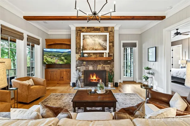 a living room with fireplace furniture and a large window