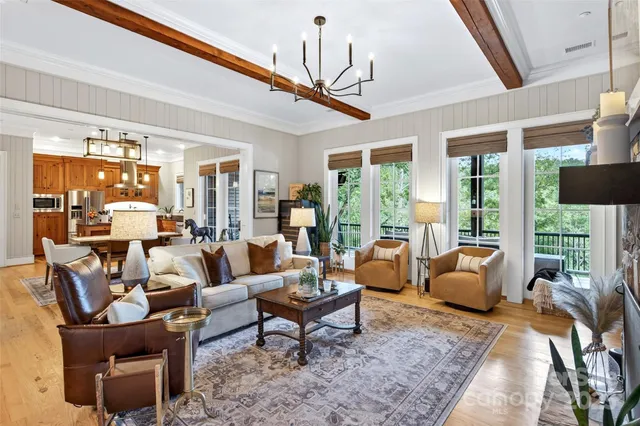 a living room with patio furniture and a floor to ceiling window