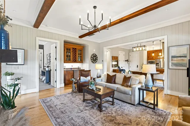 a living room with furniture a rug and a chandelier