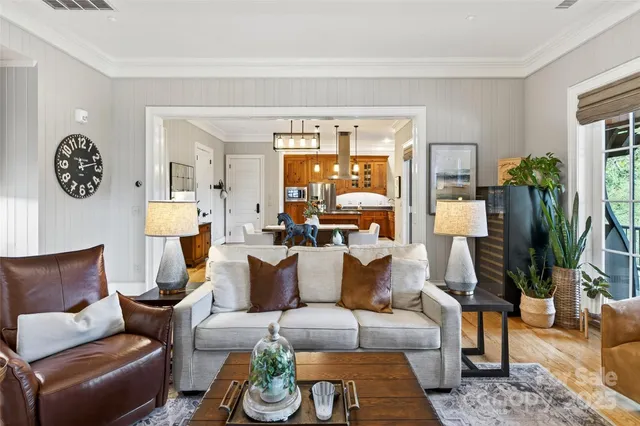 a living room with furniture and a floor to ceiling window