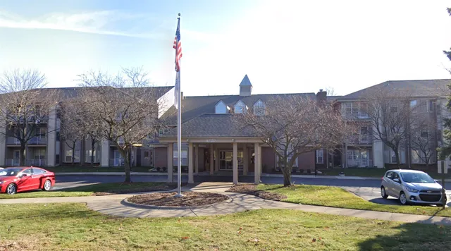 a view of a house with pool and sitting area